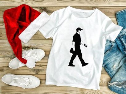 A man walking to the right with a briefcase in his hand