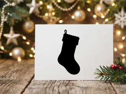 Black silhouette of a Christmas stocking isolated on a white background