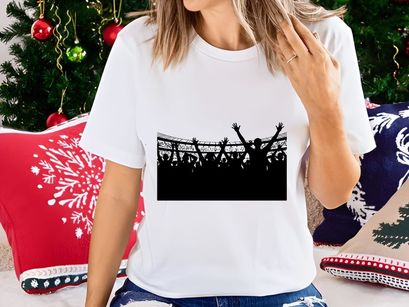 Silhouette of a crowd of people with raised hands in a stadium