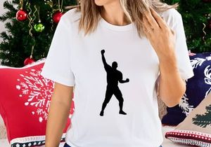 A black silhouette of a man throwing a ball with his right arm raised high
