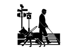 Silhouette of a blind man with guide dog crossing street