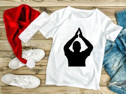 A person in a yoga pose with hands together above their head in silhouette