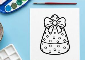 Candy corn coloring page for kids. Halloween treat illustration with a decorative bow.
