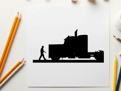 Silhouette of a man walking beside a large semi truck