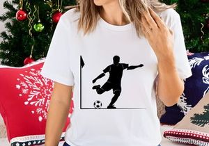 Soccer player kicking ball in corner of field with flag