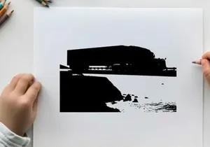 Silhouette of a large building near a body of water