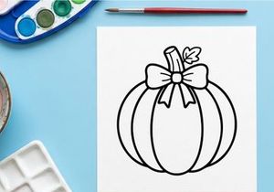 Halloween pumpkin with white ribbon bow decoration. Spooky autumn gourd tied with elegant satin gift wrap for festive fall celebration.