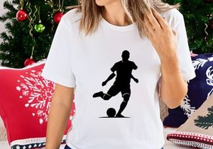 Soccer player kicking a ball in action silhouette