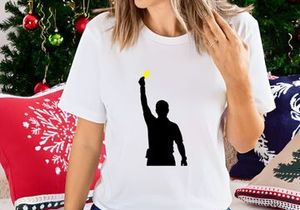 A silhouette of a man holding up a glowing yellow light source in his right hand
