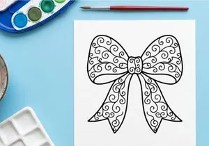 Decorative Christmas gift bow with intricate swirl pattern isolated on white background