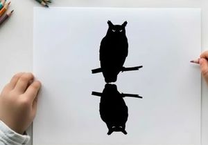 Silhouette of an owl perched on a branch with reflection