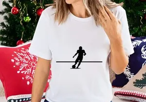 Silhouette of a soccer player kicking a ball in motion