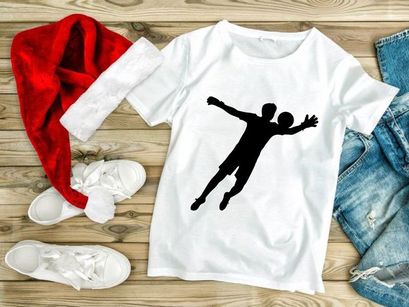 A silhouette of a person playing handball in mid air with outstretched arms and legs