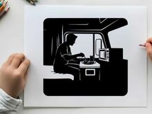 Silhouette of a man sitting in a camper van cooking
