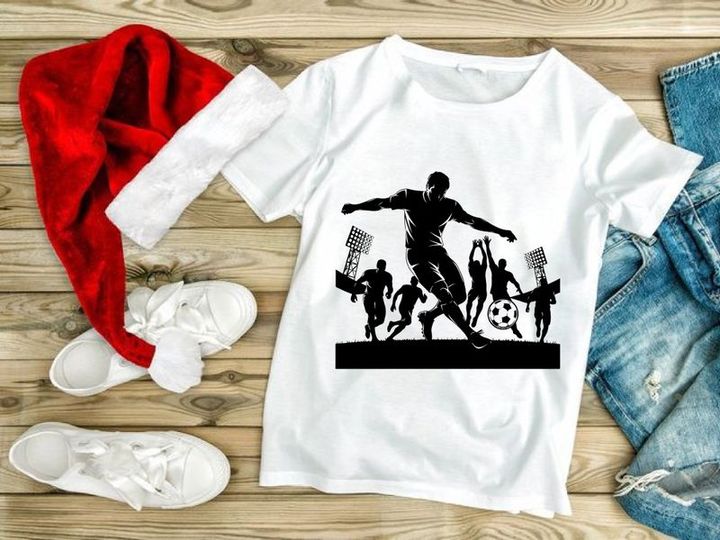 Silhouette of soccer player kicking ball with stadium lights on