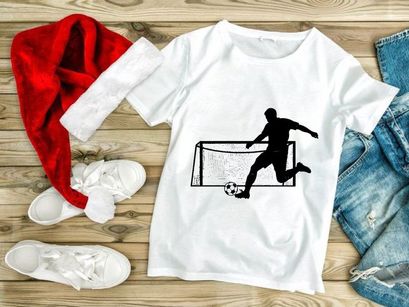 Soccer player kicking ball into goal net in action