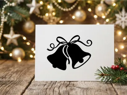 Black silhouette of Christmas bells with a decorative ribbon bow on white background