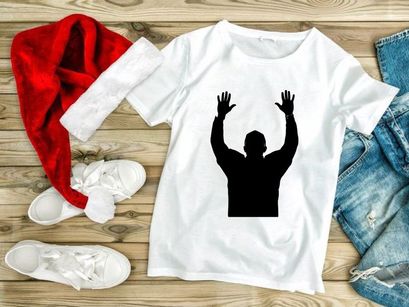 A silhouette of a man with his hands raised up in the air in celebration or triumph