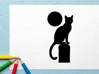 Silhouette of a Cat Sitting on a Block with a Full Moon in the Night Sky