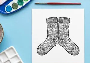 Pair of cozy knitted Christmas socks with snowflake patterns for festive holiday gifting