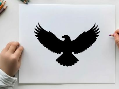Black silhouette of an eagle in flight with wings spread wide