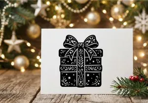Black and white Christmas gift box with bow and festive decorations