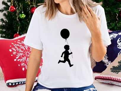 Silhouette of a child running with a balloon, joy, freedom