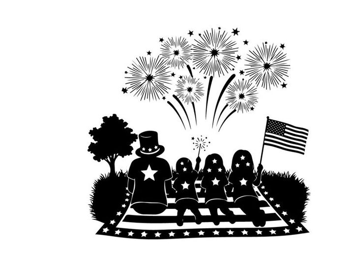 Patriotic family silhouette watching fireworks on railroad tracks