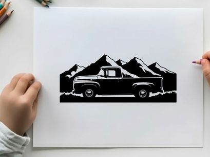 Silhouette of a vintage pickup truck in front of majestic mountain range silhouette
