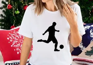 Silhouette of a soccer player kicking a ball in motion on a white background