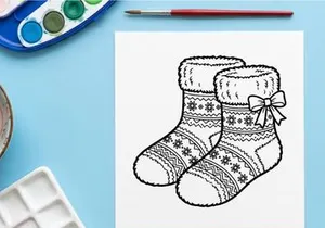 Pair of cozy Christmas socks with snowflake patterns and a bow, black and white line art.