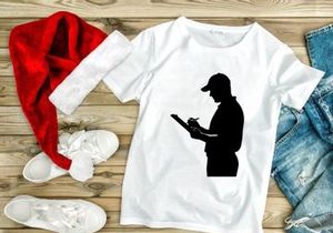 Silhouette of a man in a cap reading a document or writing