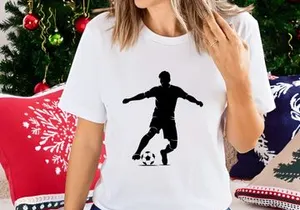Silhouette of a soccer player kicking a ball in action