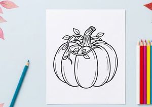 Pumpkin with vine and leaves for autumn harvest. Seasonal vegetable display for fall decor.