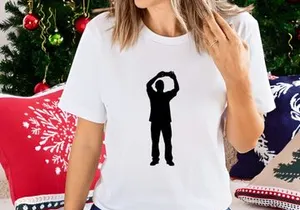 A silhouette of a man standing with his arms raised above his head in a gesture