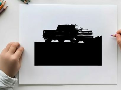 Silhouette of a pickup truck against a mountain range