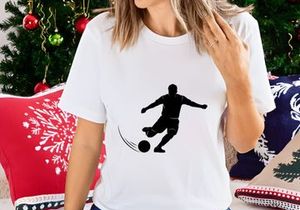Soccer player kicking a ball in motion silhouette