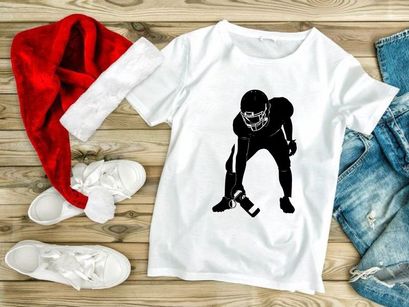 American football player in ready position with ball