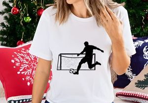 Soccer player kicking ball into goal net in action