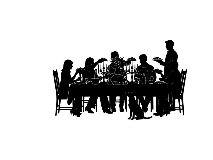 Silhouette of people gathered around a dinner table eating
