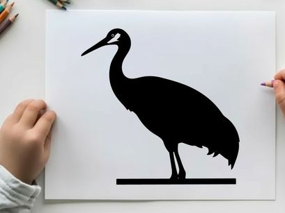 Silhouette of a standing heron bird in profile view