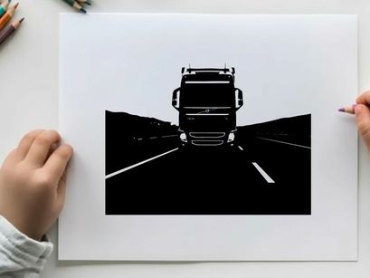 Silhouette of a large truck driving on a highway