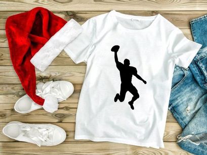 American football player catching a ball in mid air silhouette