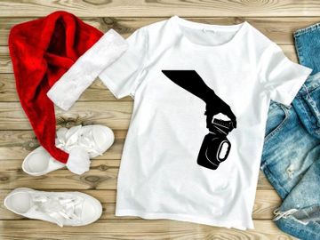 A hand grasping a camera with a lens and viewfinder preview picture