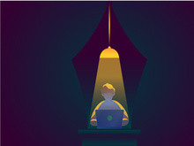 a man setting in desk in lamp light