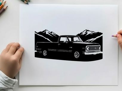 Silhouette of a classic pickup truck against mountain range silhouette