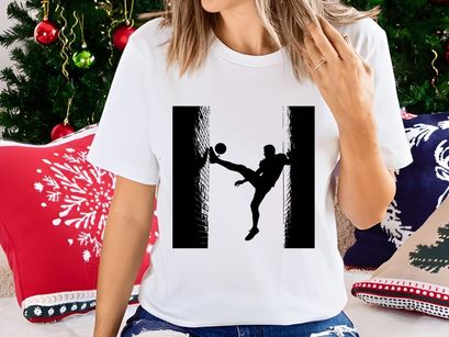 Silhouette of a soccer player kicking a ball in a dynamic pose