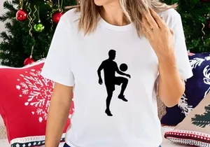Silhouette of a man kicking a soccer ball in mid air motion