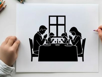Family in silhouette praying at dinner table together