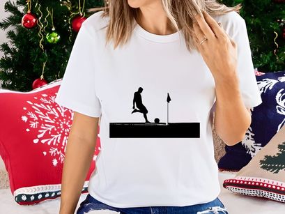 Silhouette of a soccer player kicking a ball on a field with goalpost